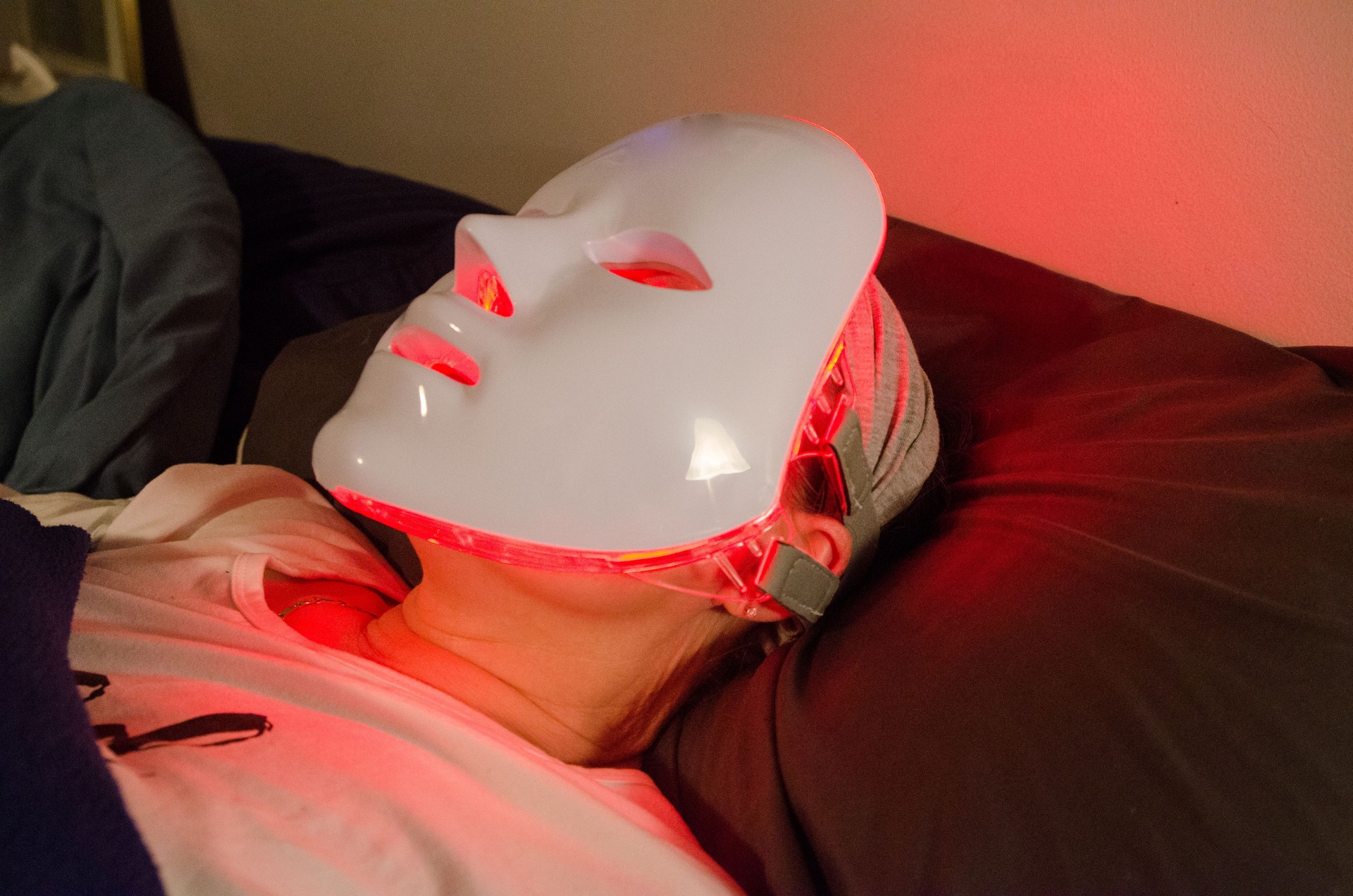 Headshot of woman with light therapy facial mask